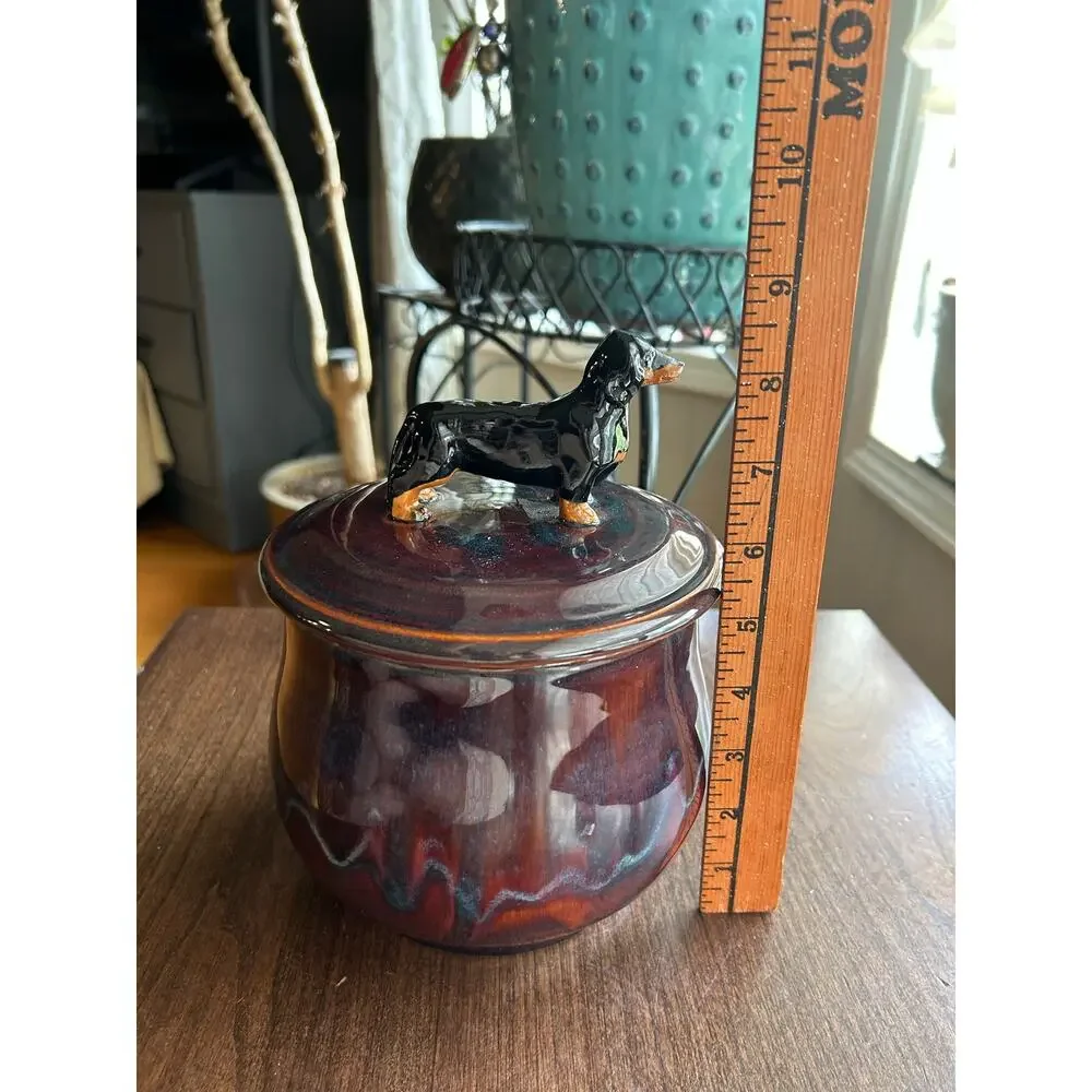 Mudipaws Pottery ceramic treat jar topped w/ a dachshund by artist Debi Manduca
